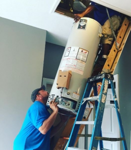 Plumbers installing a water heater